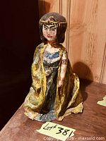Front view of hand-painted Egyptian figurine showing facial features, clothing and overall appearance