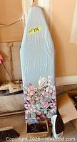 Full view of ironing board standing upright