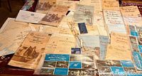 Group of folded Canadian nautical charts spread on table with navigation tools