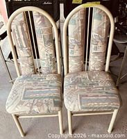 Front view of both chairs showing upholstery pattern and metal frames