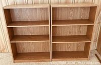 Front view of both matching bookcases showing shelves and finish