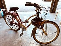 Full view of Schwinn Jaguar cruiser bicycle with helmet on handlebar