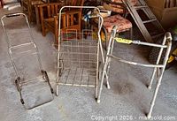 Three mobility items: luggage dolly, grocery cart, walker