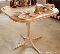 Overall view of table top and base with items resting on it