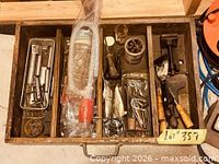 Drawer containing siphon pump, vise and assorted hardware