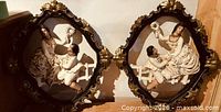 Both oval plaques side by side