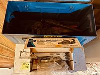 Toolbox with wrenches, boxed macerator pump on top