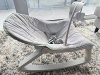 Side view of rocker showing gray seat, mint trim, white frame