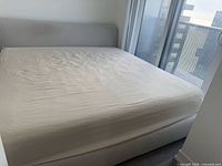 Full view of assembled king upholstered bed showing headboard and mattress platform