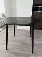 Round black-brown dining table front view