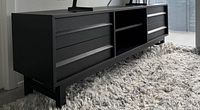 angled side view of entire black media console on rug