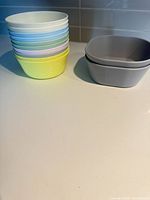 Stack of pastel bowls beside nested grey bowls