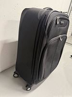 Left side view of black Samsonite spinner suitcase