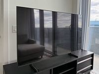 Front view of Samsung television on media console