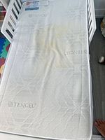 Top view of mattress in crib showing overall surface and stain