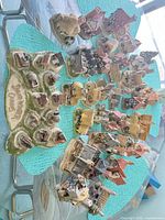 Entire assortment of David Winter cottages arranged on display base