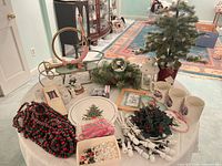 Overview of table showing tree, lights, plate, mugs, lantern, garlands and assorted decorations