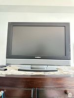 Front view of Insignia TV on stand