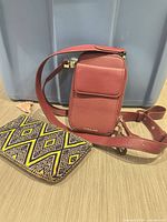 Front view of burgundy phone crossbody and woven pouch