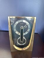 Front view of Seiko brass-plated mantel clock showing dial and case