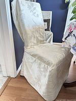 Slipcovered chair front view shows color, pattern and drape