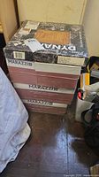 Stack of four tile boxes: one Dynamix, three Marazzi