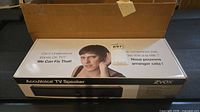 Retail box top showing ZVOX AccuVoice TV Speaker branding and graphics