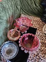Four pieces of glassware on fabric showing color and form