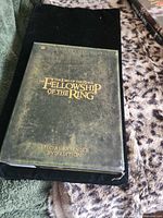Front of green slipcase showing title and surface wear
