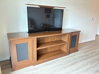 Front view of TV stand with Samsung TV lowered and top panel extended