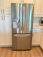 Full front view of refrigerator showing French doors and bottom freezer