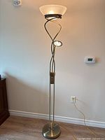 Full view of torchiere floor lamp showing shade, reading light, twisted poles and base