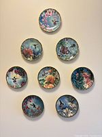 Front view all eight plates arranged on wall