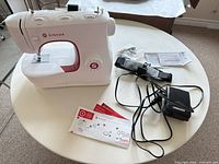 Sewing machine with all included accessories on table