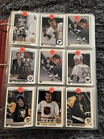 Binder page showing nine NHL player cards including Mario Lemieux and Campbell Conference card