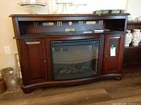 Front view showing fireplace insert, cupboards, curved design