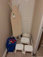 Overall lot: ironing board, four step stools, blue reusable bag