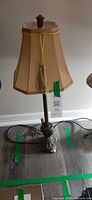 Full view of table lamp showing base, column and shade
