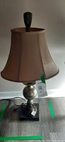 Full view of lamp showing base, body, shade, cord