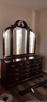 Front view of mahogany dresser with attached triple mirror