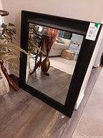 Mirror front angled view against wall