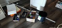 Group view of LED strip light, copy paper, tin, organizer with stapler, box of stationery, wastebasket