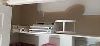 Overview of shelf with organizers, turntable and liner rolls
