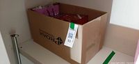 Cardboard box holding art supplies