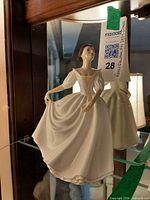 Front view of Donna figurine on glass shelf