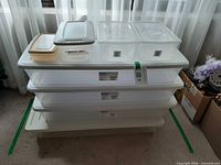 Stack of four large totes with smaller bins on top