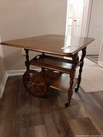Bar cart angled view showing drop leaf and wheels