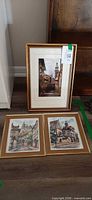 Group shot of three framed hand-colored etchings