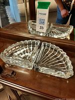 Two fan-shaped crystal dishes shown together on table