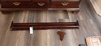 Full view of wood wall shelf and one bracket
